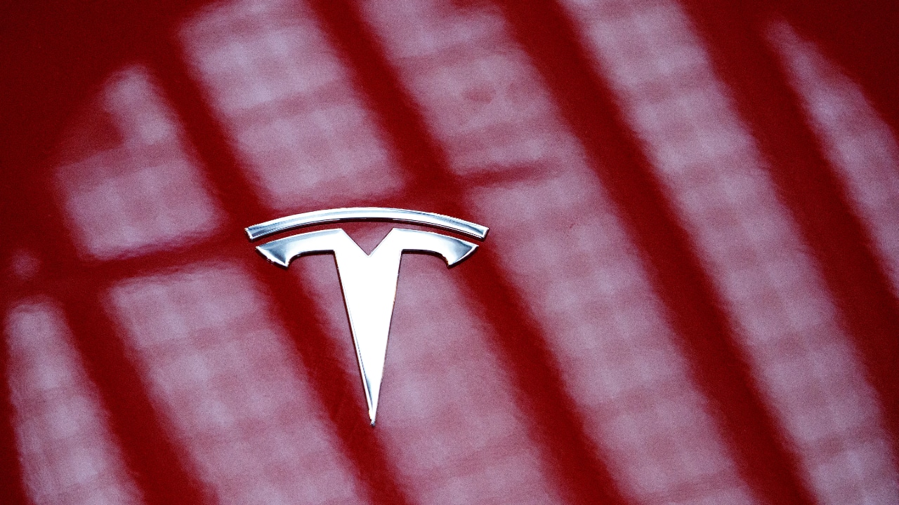 Tesla profits tumble on higher costs, tariff drag