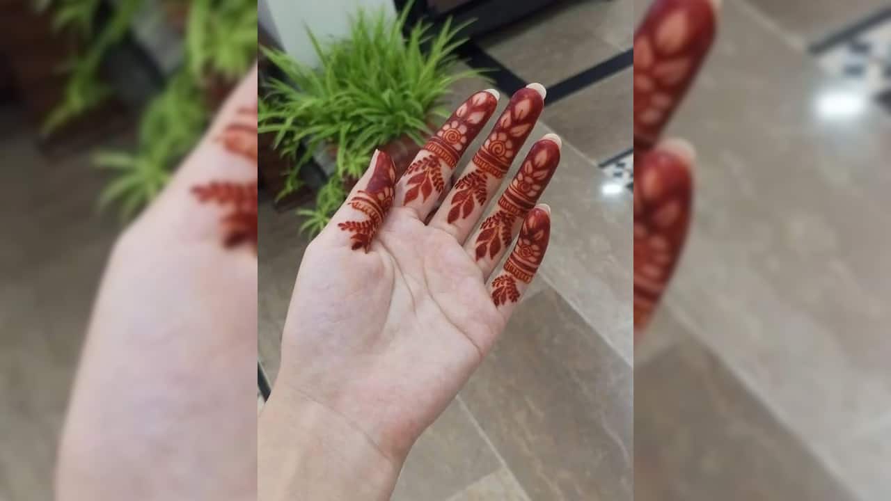 Decorate only the fingertips with tiny blooms, leaves, or spirals. It’s simple and eye-catching. (image: Fronthandmehndidesign)