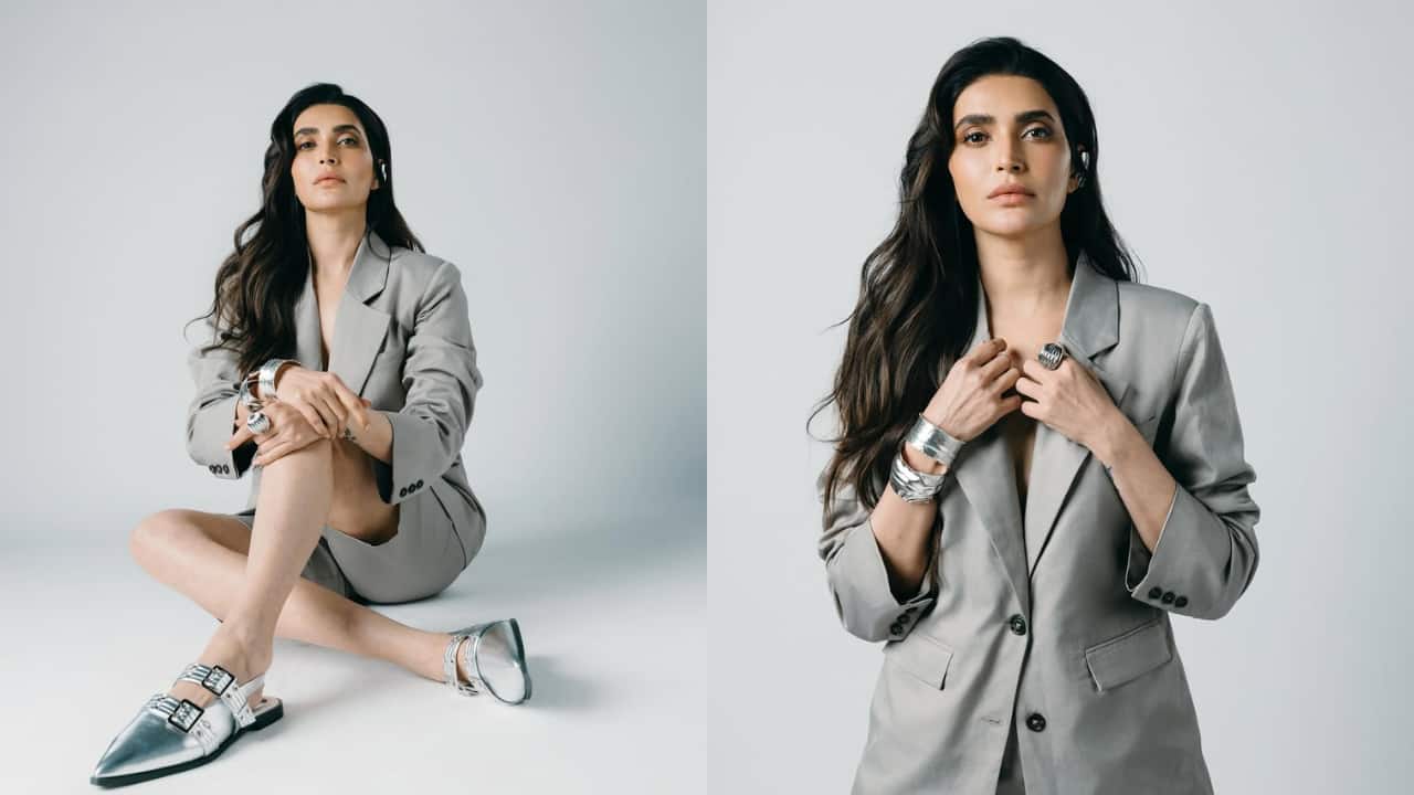 Karishma Tanna Karishma’s ensemble is quite a spin on the traditional pantsuit. Going all grey, her blazer is paired with shorts and worn with glossy metallic shoes for a glamorous touch. This is just one way pantsuits can be made to look formal and a tad casual.