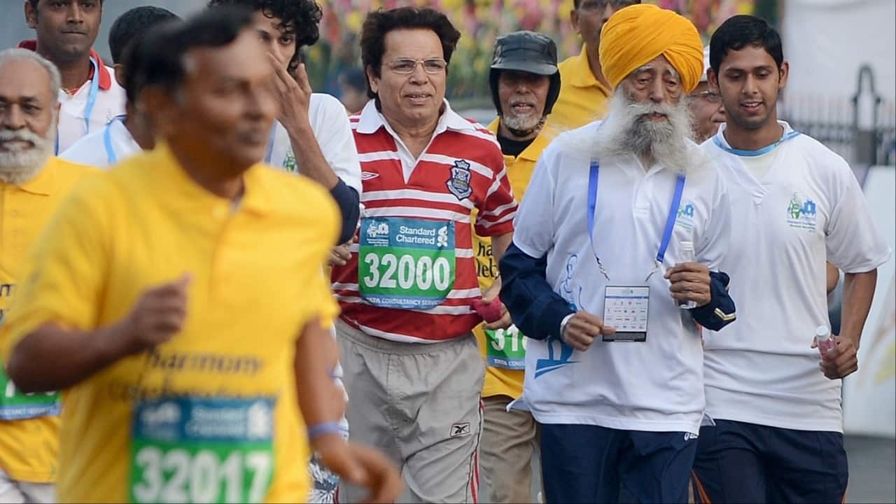 This file photo taken on January 20, 2013 shows centurian marathon runner Fauja Singh (2nd R) taking part in the Mumbai Marathon. (Image credit: AFP)