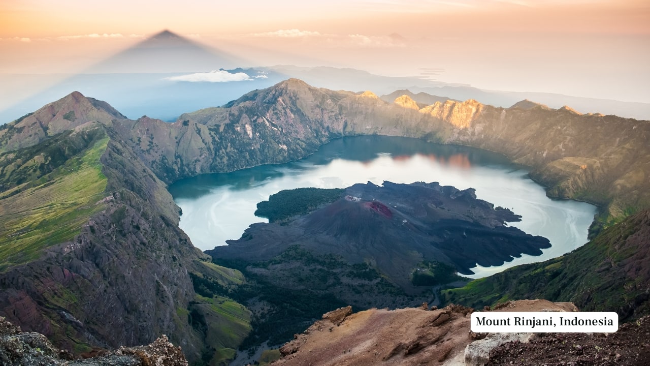 4. Mount Rinjani, Indonesia – 3,726 m Dominating Lombok’s skyline, Mount Rinjani is a physically demanding trek that winds through rainforests, alpine meadows, and volcanic ash. Climbers often camp at the crater rim overlooking the Segara Anak caldera lake and the smouldering inner cone. Multi-day guided treks are essential due to unpredictable terrain and weather shifts. (Image: Canva)