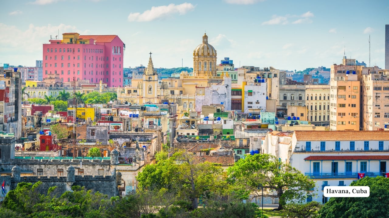 5. Havana, Cuba: Time-Faded Pastels and Resilient Charm Havana’s chromatic identity is less about precision and more about patina. Faded teals, chipped yellows, and dusty pinks dominate its colonial architecture. These hues are intensified by age, humidity, and nostalgia. Classic 1950s cars, themselves relics of another era, roll through streets that seem bathed in sepia-toned memory. (Image: Canva)