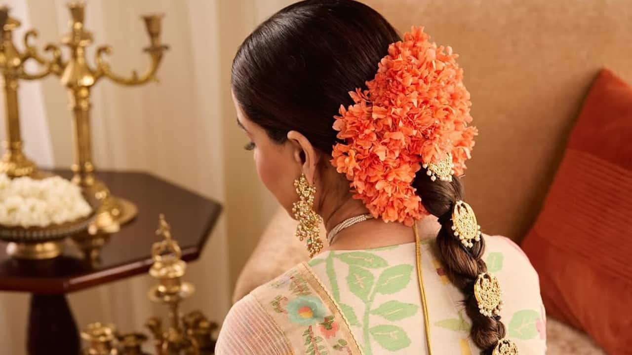 Marigold charm Genelia’s intricate jewelry and the soft pink blouse add depth and character to the overall outfit. Orange flowers braided into her hair add a festive touch. Marigold charm Genelia’s intricate jewelry and the soft pink blouse add depth and character to the overall outfit. Orange flowers braided into her hair add a festive touch.