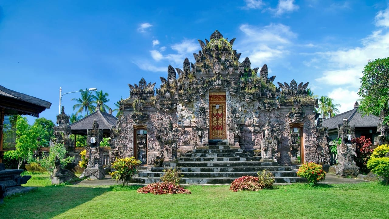 9. Pura Beji Sangsit: A Hidden Temple of Intricate Carvings Located in the village of Sangsit in North Bali, Pura Beji is a serene temple famed for its elaborate stone carvings and unique architectural style. Unlike the bustling temples near Ubud, it offers a peaceful atmosphere where visitors can appreciate Bali’s rich artistic heritage in quiet contemplation. What makes it unique: The temple’s detailed decorations and tranquil setting provide a glimpse into traditional Balinese craftsmanship away from tourist crowds. (Image: Canva)