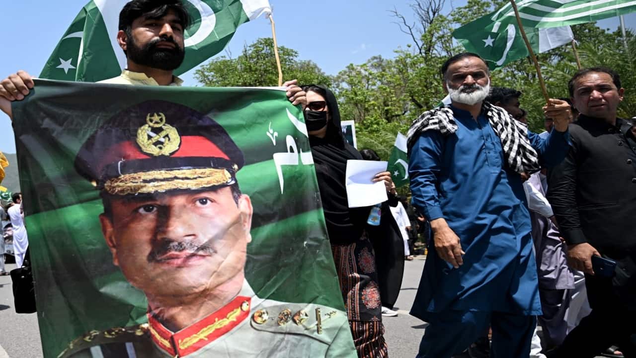 A man carries a portrait of Munir, during a rally to express solidarity with Pakistan's armed forces, in Islamabad early this May.