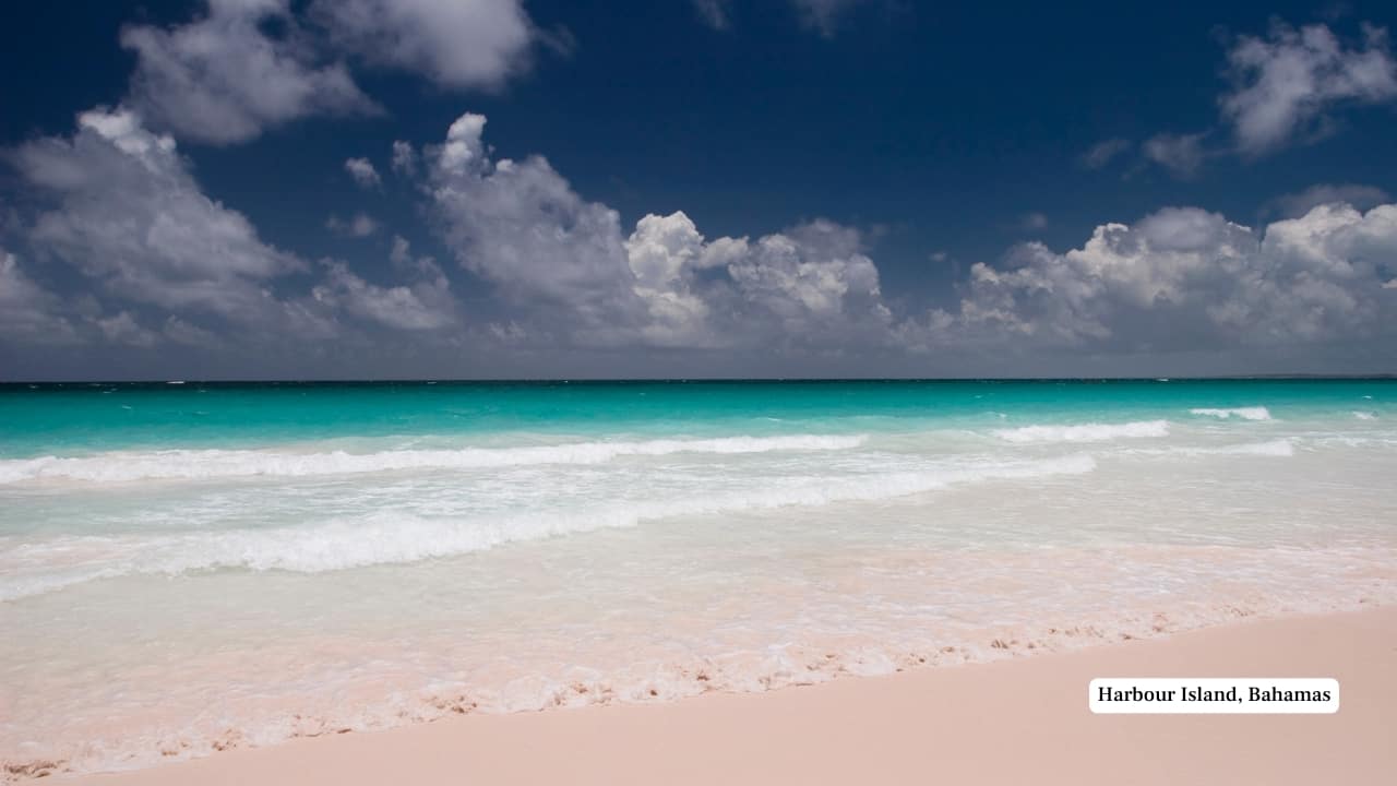 5. Harbour Island, Bahamas Famed for its blush-pink beaches and pastel-toned cottages, Harbour Island is elegance in soft focus. The town of Dunmore exudes timeless charm—think bougainvillea-draped verandas, brightly painted shutters, and vintage golf carts cruising down narrow lanes. (Image: Canva)