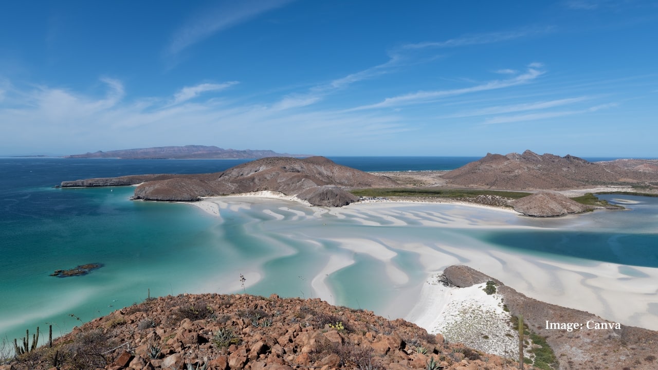 9. Balandra Lagoon, Mexico Located in the Sea of Cortez near La Paz, Balandra is revered for its shallow turquoise waters and protected ecosystem. Surrounded by cacti and rust-coloured cliffs, it offers a desert-meets-sea experience rarely found elsewhere. (Image: Canva)