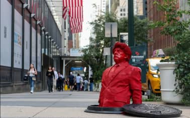Life-size red Trump sculpture emerging from manhole installed in Manhattan | SEE PICS