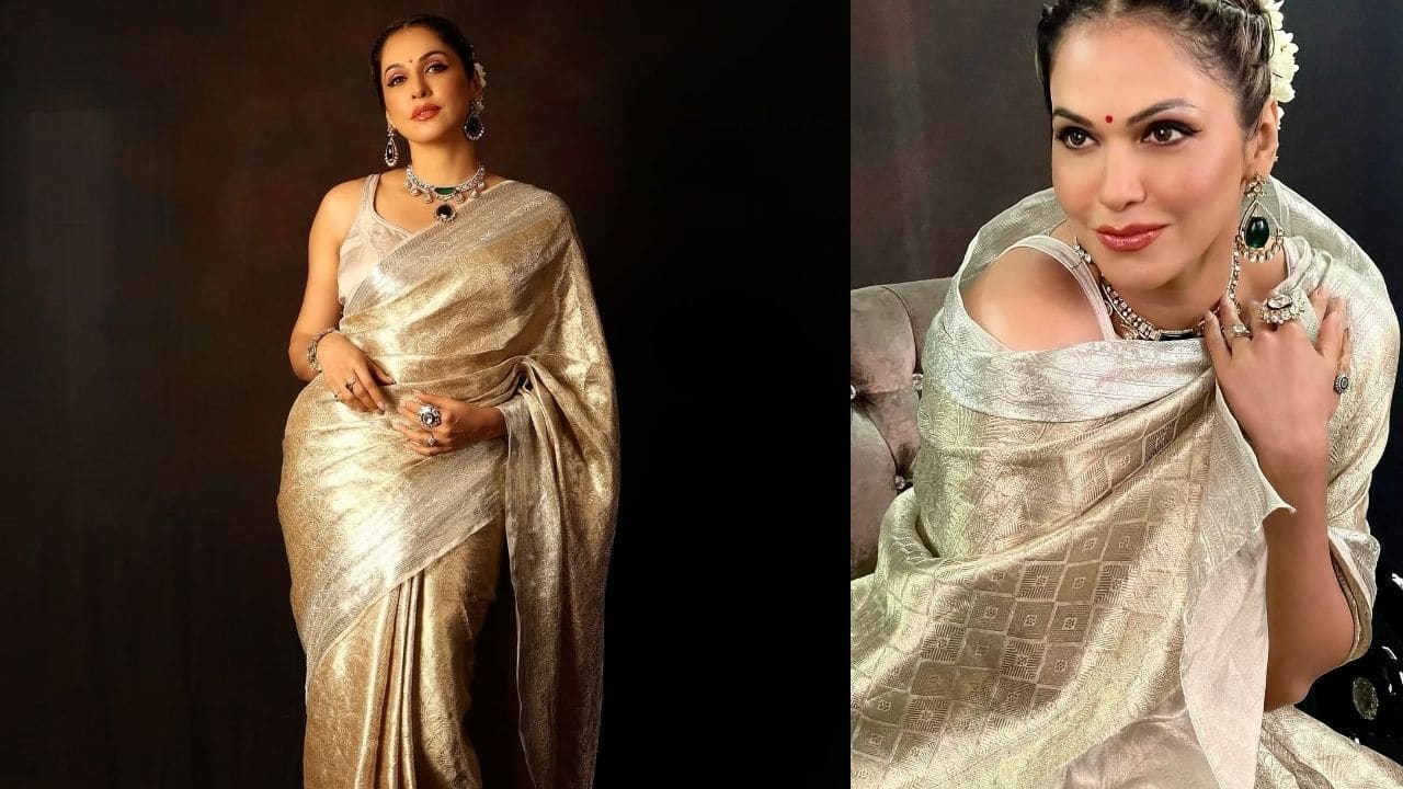 In this gorgeous golden metallic saree that perfectly combines traditional and modern glamour, Isha exudes sophistication. While the traditional saree silhouette retains its timeless elegance, the glossy fabric produces lovely draping and catches light beautifully. In this gorgeous golden metallic saree that perfectly combines traditional and modern glamour, Isha exudes sophistication. While the traditional saree silhouette retains its timeless elegance, the glossy fabric produces lovely draping and catches light beautifully.