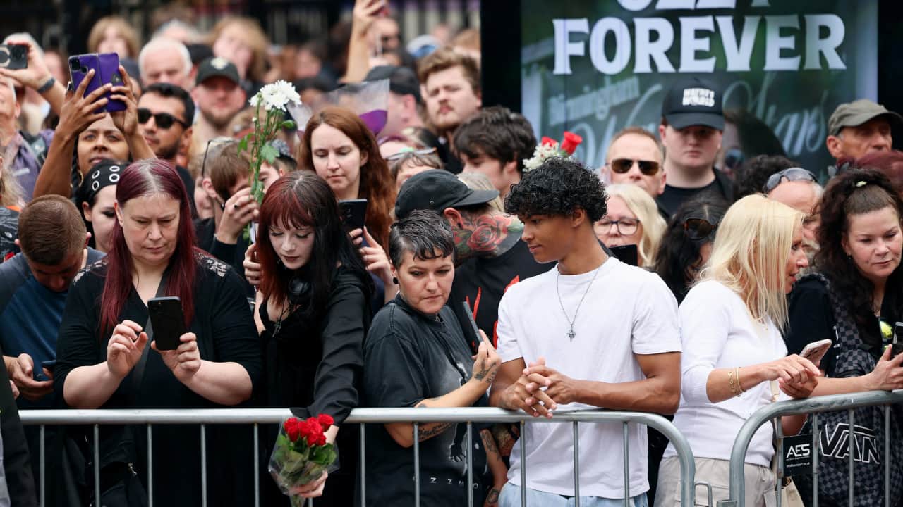 People gather on the day of the funeral cortege of Ozzy Osbourne, the former Black Sabbath frontman, in Birmingham, Britain, July 30, 2025. REUTERS/Jack Taylor