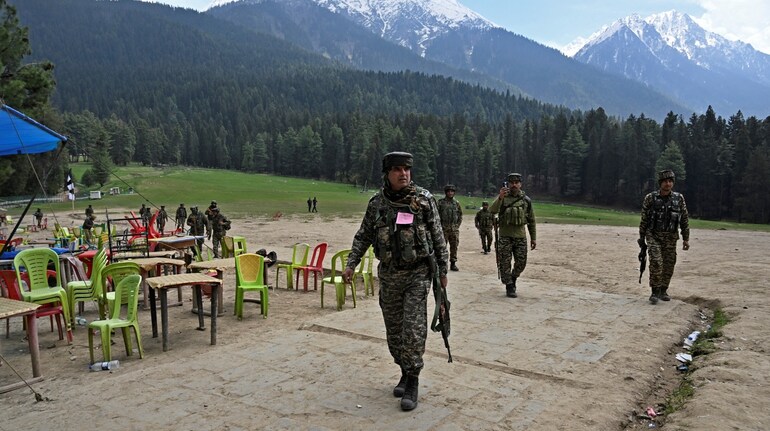 File photo of security personnel inspecting the site in the aftermath of an attack as food stall chairs lie empty in Pahalgam, about 90 km (55 miles) from Srinagar on April 23, 2025.