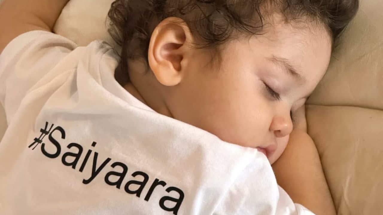 Adorable baby River  One particularly endearing image shows River fast asleep on a light-colored pillow, wearing a white t-shirt with &quot;#Saiyaraa&quot; on the back. This candid shot highlights the peaceful innocence of childhood, adding a sweet and personal touch to the collection.