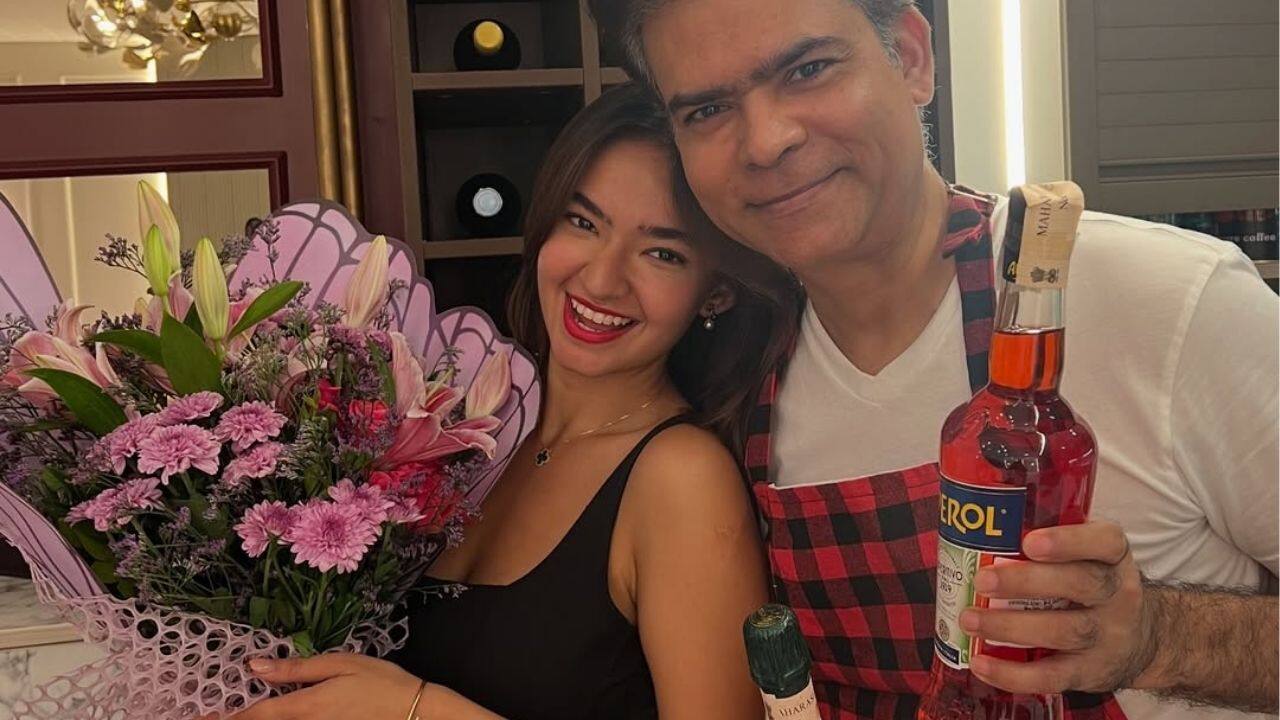 For her special day, Anushka opted for a black short dress, pairing it with bold red lipstick and loose, flowing hair. She looked radiant and elegant in every frame. She shared a cute image with her father. 
