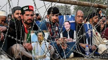 File Photo - Supporters of jailed former prime minister Imran Khan hold his posters during a gathering by the Pakistan Tehreek-e-Insaf (PTI) party to observe Martyrs' Day to honour those who allegedly died during last month's protest, in Peshawar on December 15, 2024. (Photo by Abdul MAJEED / AFP)