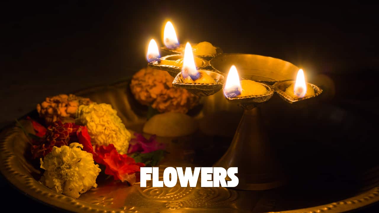 Fresh flowers in the thali are a sign of devotion and are offered to both the deities and the brother for blessings and beauty. (image: canva)