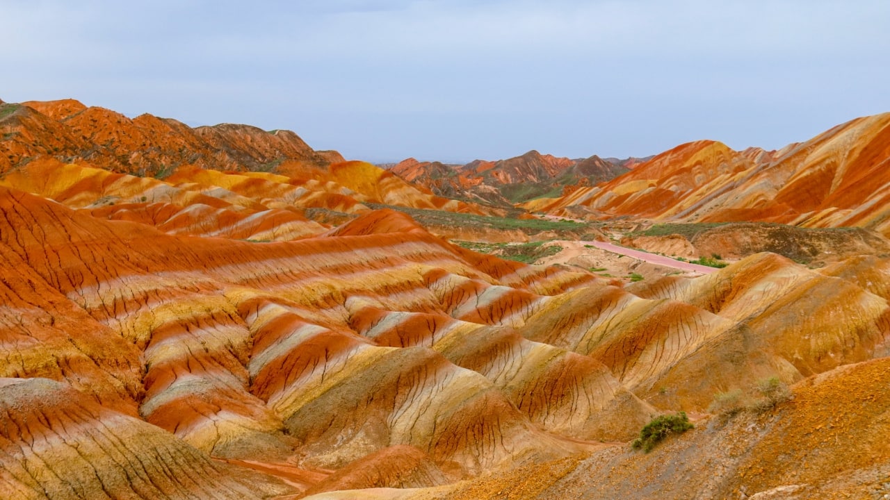 7. Zhangye Danxia Landform, China Known as the “Rainbow Mountains,” these rock formations display dramatic stripes in hues of red, orange, yellow, and green. The vivid colors create an almost painterly landscape, a geological wonder shaped over millions of years. (Image: Canva)