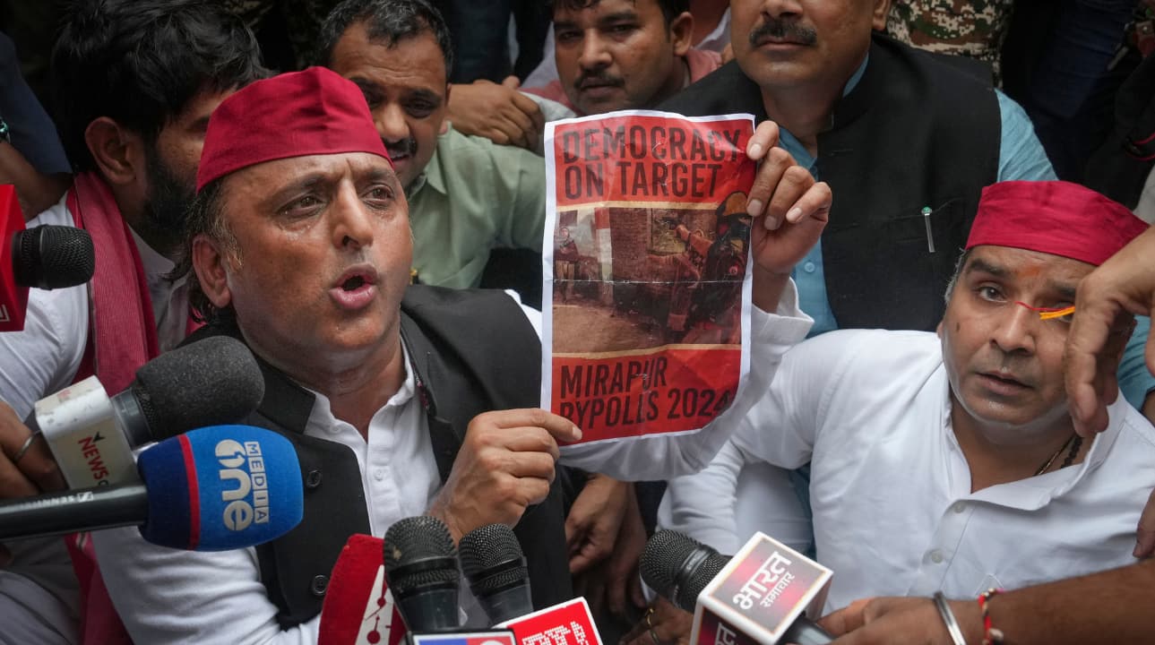 Samajwadi Party MPs Akhilesh Yadav, Dharmendra Yadav with others during the protest march. "They are using the police to stop us...," said Akhilesh Yadav as he sat down to protest while police stopped the opposition MPs from marching towards the Election Commission of India. (Image: PTI)