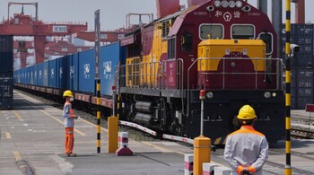 Workers watch as a train loaded with containers leave Chongqing Railway Container Terminal Station in southwest China's Chongqing Municipality on Tuesday, May 20, 2025. (Image used for representational purpose)