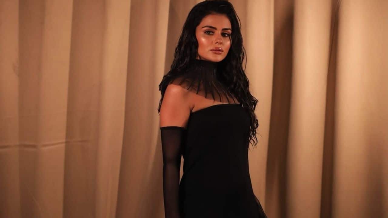 High Neck Black Look – ’90s Vibes  Channelling retro charm, Priyanka rocks a high-neck black outfit that gives off vintage ’90s energy. Sleek hair and minimal accessories keep the focus on her timeless style.