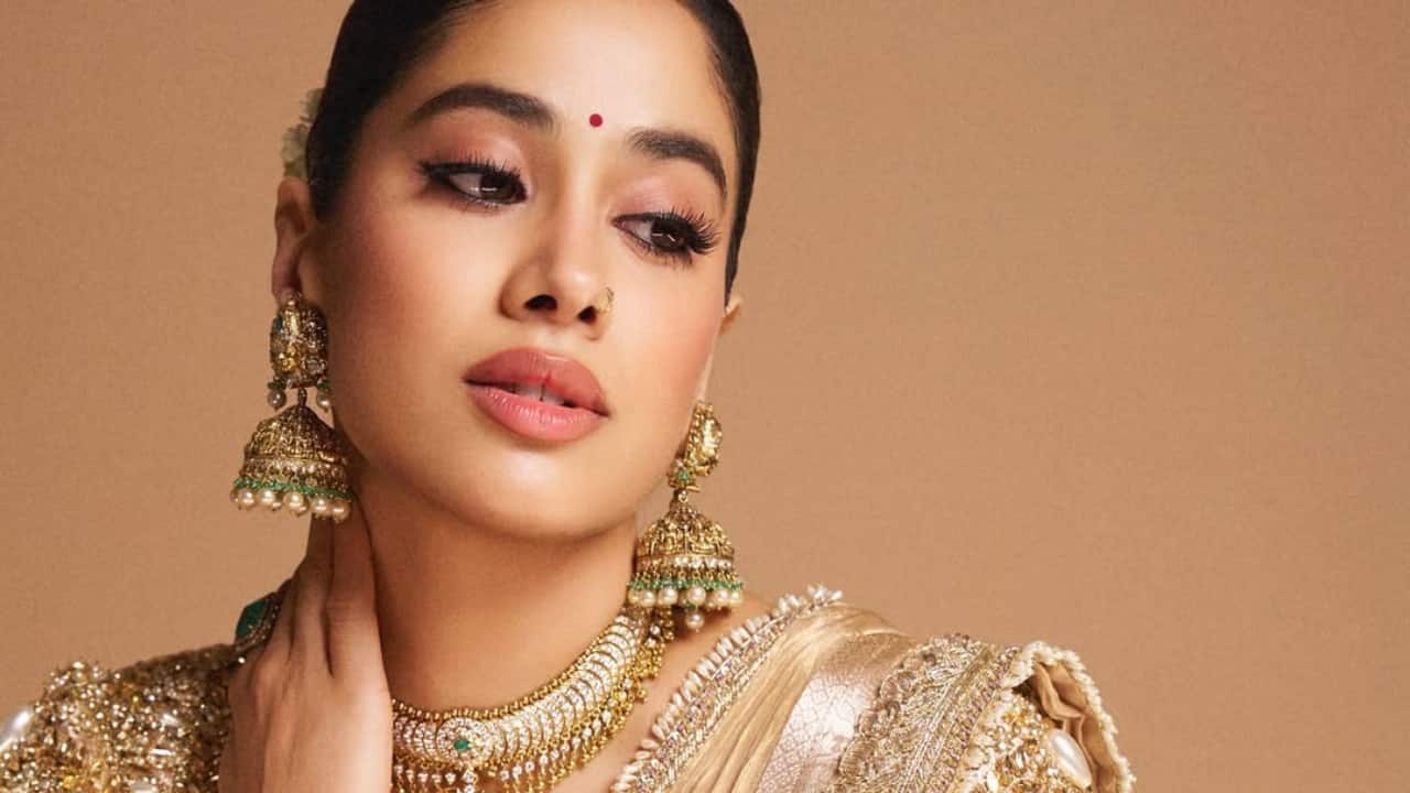 4. The backless blouse with pearl tassel detailing gives the outfit a statement-making twist.