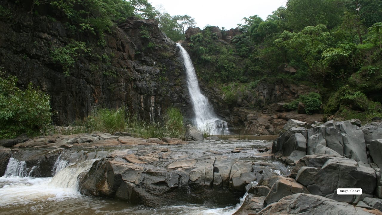 4. Ninai Waterfalls – Valsad District Surrounded by lush forests, Ninai Waterfalls is relatively untouched, offering a quiet retreat. The cascading waters and rocky terrain make it popular among trekking enthusiasts. (Image: Canva)
