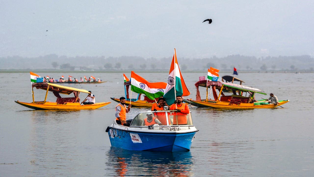 People ride boats and 'shikaras' as they take part in a 'Tiranga rally' at the Dal Lake in Srinagar.