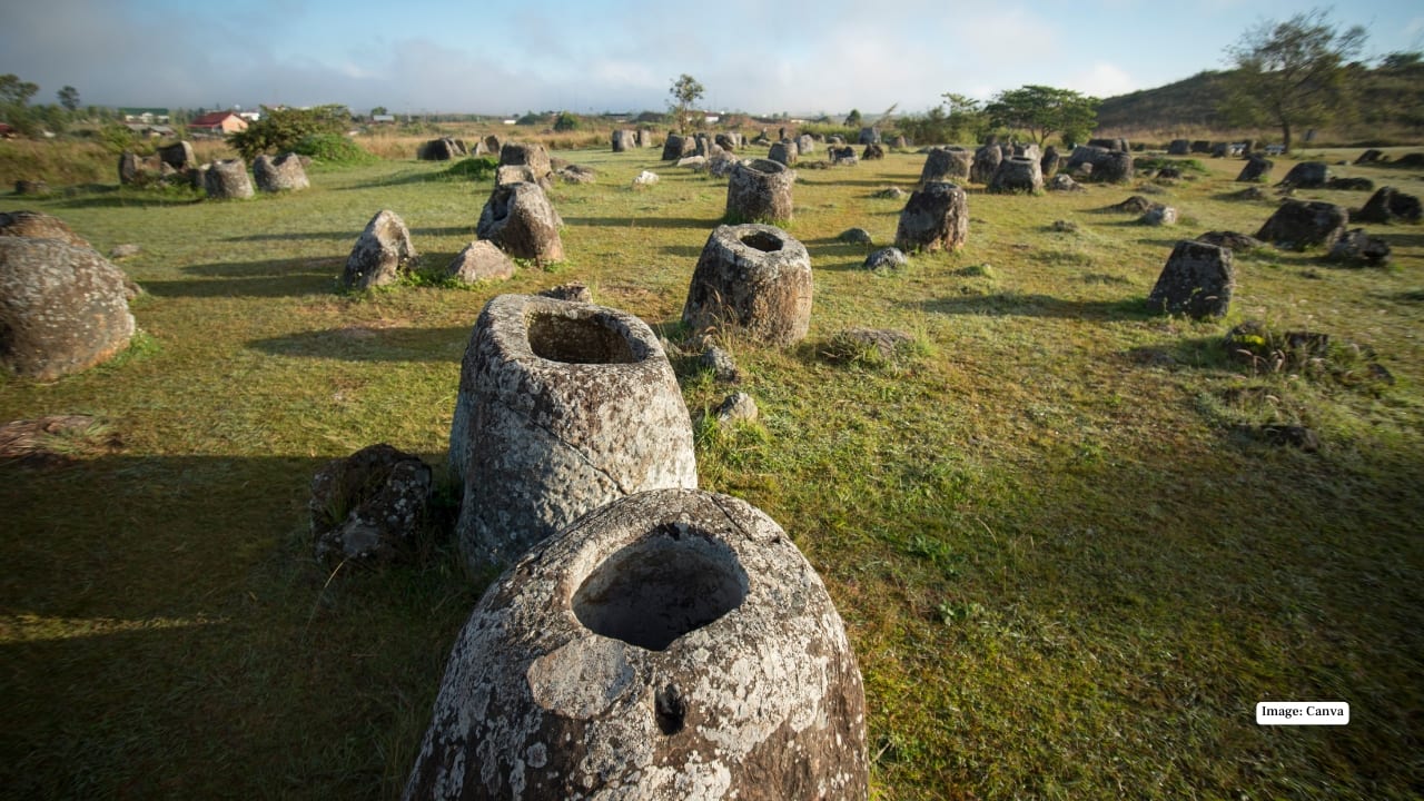5. Plain of Jars – A mysterious archaeological site dotted with hundreds of ancient stone jars over 2,000 years old, offering insight into prehistoric cultures and scenic views. (Image: Canva)