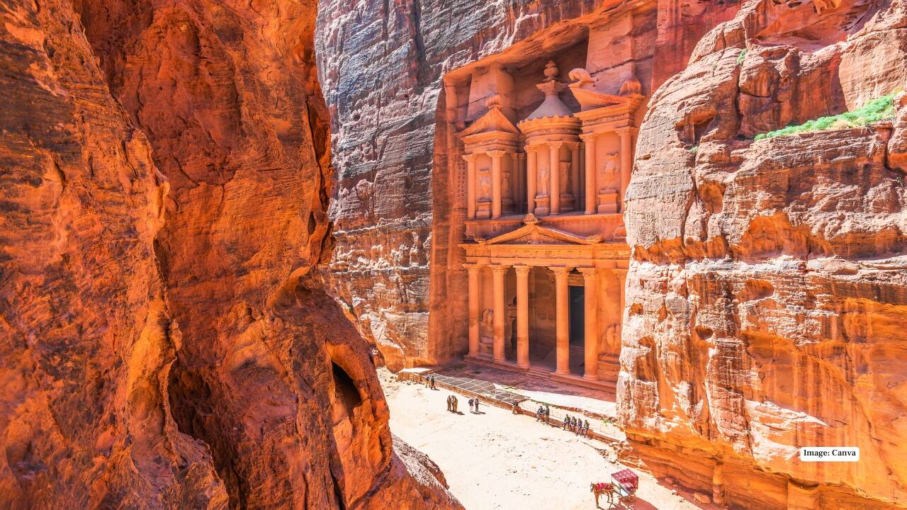1. Petra – The Rose-Red Wonder No trip to Jordan feels complete without wandering through Petra. This UNESCO World Heritage site, famously carved into rose-hued cliffs, is a mesmerizing testament to the Nabatean civilization. Walk the winding Siq, a narrow canyon that reveals the iconic Treasury (Al-Khazneh) in all its glory, and explore royal tombs, ancient streets, and archaeological marvels that tell stories centuries old. (Image: canva)