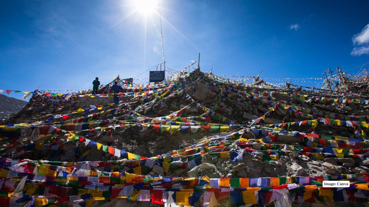 Chang La At over 17,000 feet, Chang La is the gateway to the stunning Pangong Lake. The challenging climb, fluttering prayer flags, and panoramic Himalayan views make it a journey you’ll never forget. (Image: Canva)