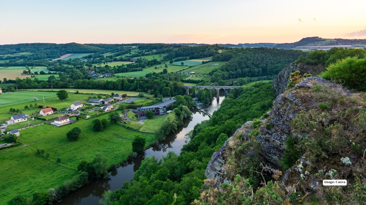5. Clécy (Calvados, Normandy) Known as the “Normandy capital of outdoor sports,” Clécy blends adventure with beauty. Its rolling hills, river views, and charming medieval streets create an unforgettable destination for nature lovers and explorers. (Image: Canva)
