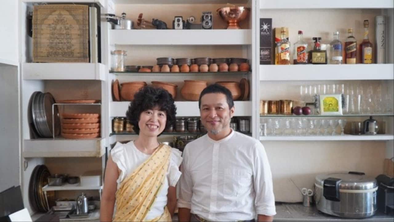 Japanese chef Koji Nakayama, 50, and his wife Sachiko, 45, pose in their kitchen which is well-stocked with traditional Bengali earthenware. (Image credit: Moneycontrol)
