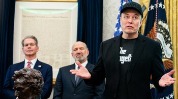 File Photo - Elon Musk, alongside Secretary of Treasury Scott Bessent (L) and Secretary of Commerce Howard Lutnick (C), speaks during a news conference with US President Donald Trump in the Oval Office of the White House in Washington, DC, on May 30, 2025.
