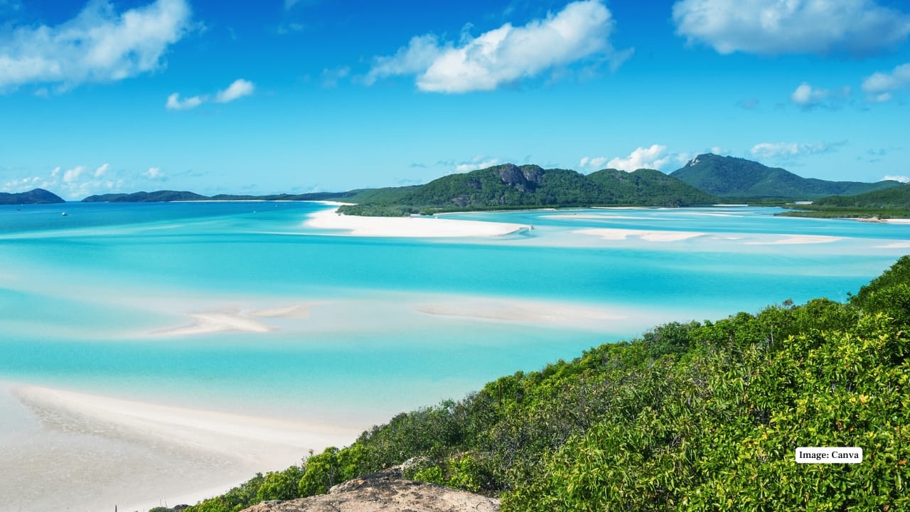 2. Whitehaven Beach, Australia Nestled in the Whitsunday Islands, this pristine stretch features nearly pure silica sand that stays cool to the touch. Its swirling patterns merge with clear blue waters—best viewed from Hill Inlet by boat or seaplane. (Image: Canva)