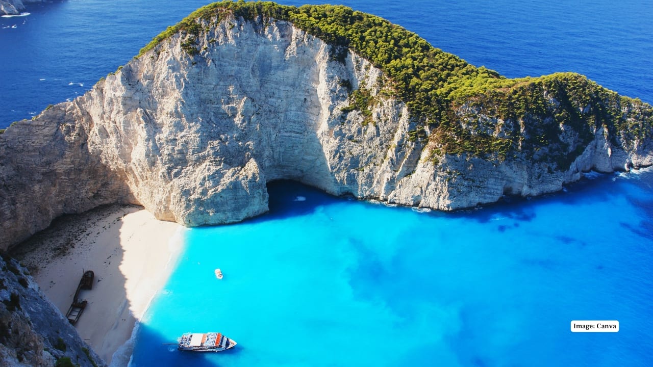 5. Navagio Beach, Zakynthos (Greece) Also known as Shipwreck Beach, it’s a dramatic cove flanked by towering limestone cliffs and azure sea. Accessible only by boat, its iconic wreck and scenery make it one of the most photographed beaches globally. (Image: Canva)