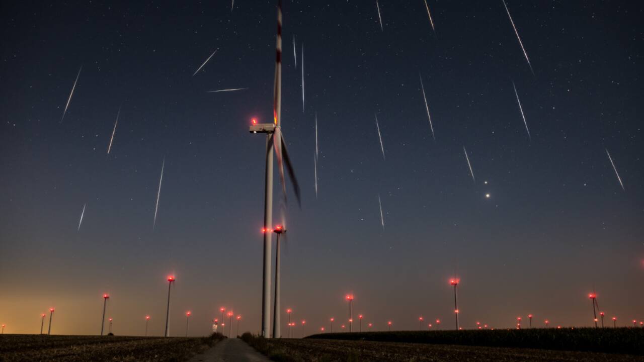 Mostly Perseids: Perseid meteors streak over Austria, converging toward Perseus, captured in 500-exposure composite, with Jupiter and Venus glowing above wind turbines in early August predawn sky. (Image: NASA)