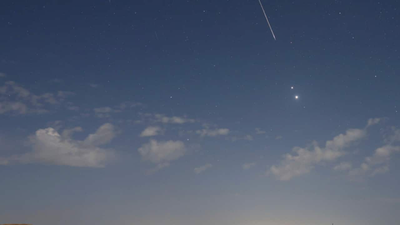 Moonlight, Planets, and Perseids: On August 13, Venus, Jupiter, and Perseid meteors lit up Gansu’s predawn sky, reflecting in a pond despite the waning gibbous Moon’s glare. (Image: NASA)