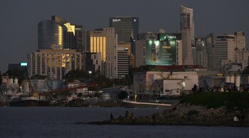 Skyline of Buenos Aires city is seen during the dusk from the Rio de la Plata river in Buenos Aires on May 11, 2025. (Photo by JUAN MABROMATA / AFP)