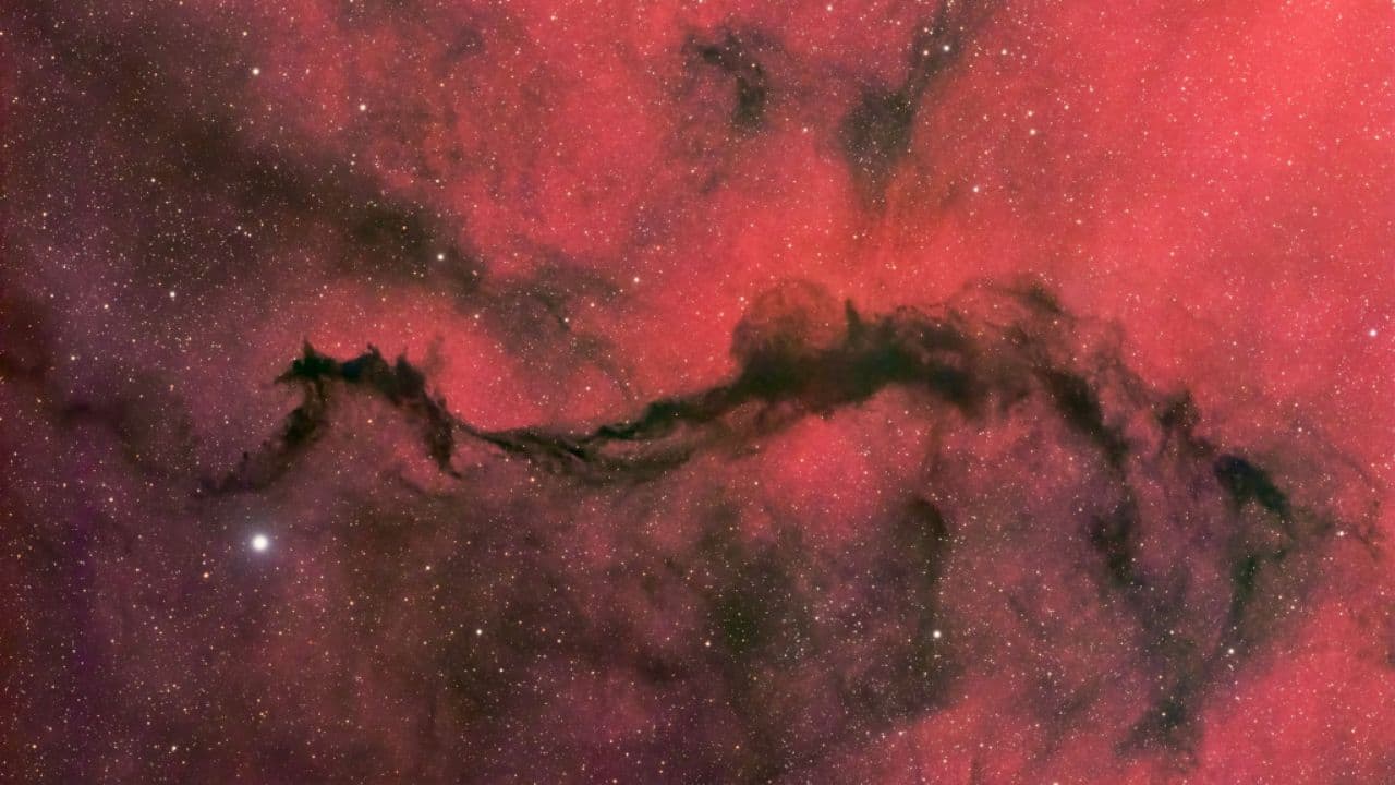 NASA’s Picture of the Day: A dark nebula forms as a veil meets a faint glow in the Ophiuchus constellation