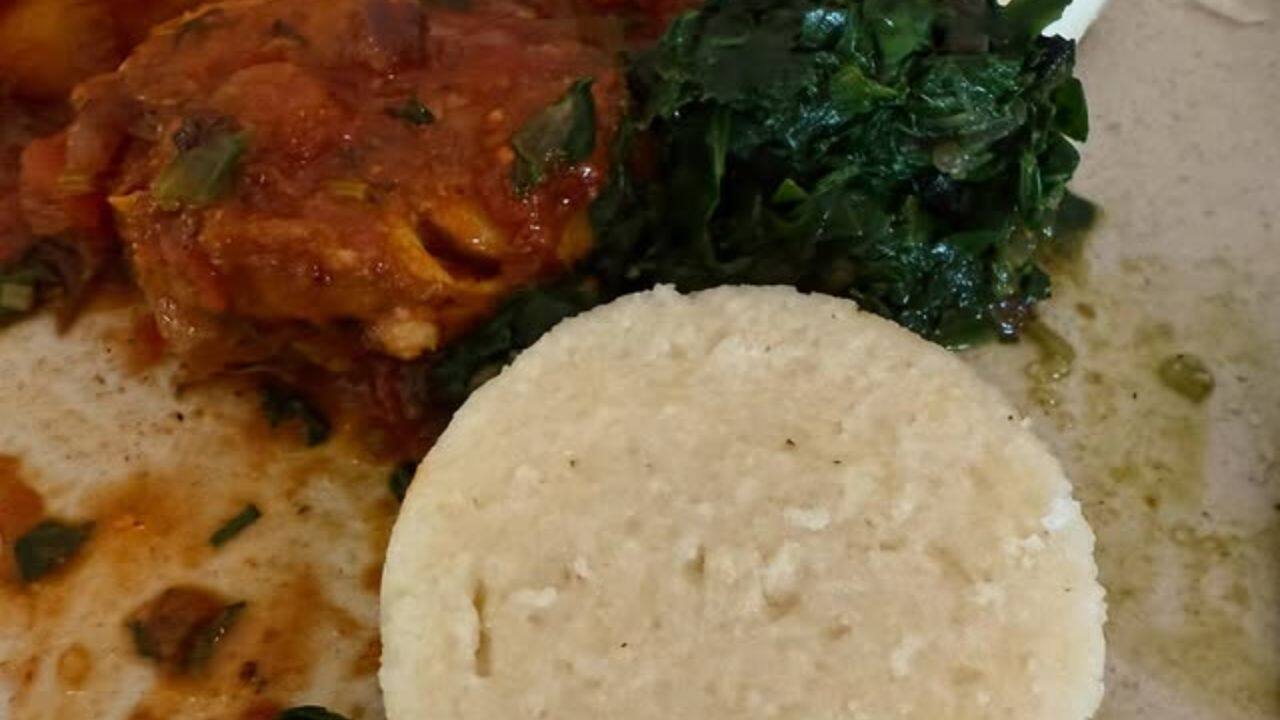 Local Cuisine Delight She tasted local flavors with a plate of white dumpling-like delicacies, leafy greens, and a tomato-based curry. Local Cuisine Delight She tasted local flavors with a plate of white dumpling-like delicacies, leafy greens, and a tomato-based curry.