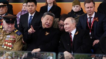 File Photo - In this pool photograph distributed by the Russian state agency Sputnik, Russia's President Vladimir Putin and Chinese President Xi Jinping attend the Victory Day military parade at Red Square in central Moscow on May 9, 2025. 