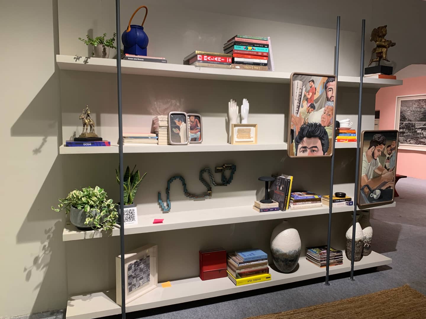 Art displayed in and on the bookshelf, at 'Taqiya Qalam', 2025 DCAW.