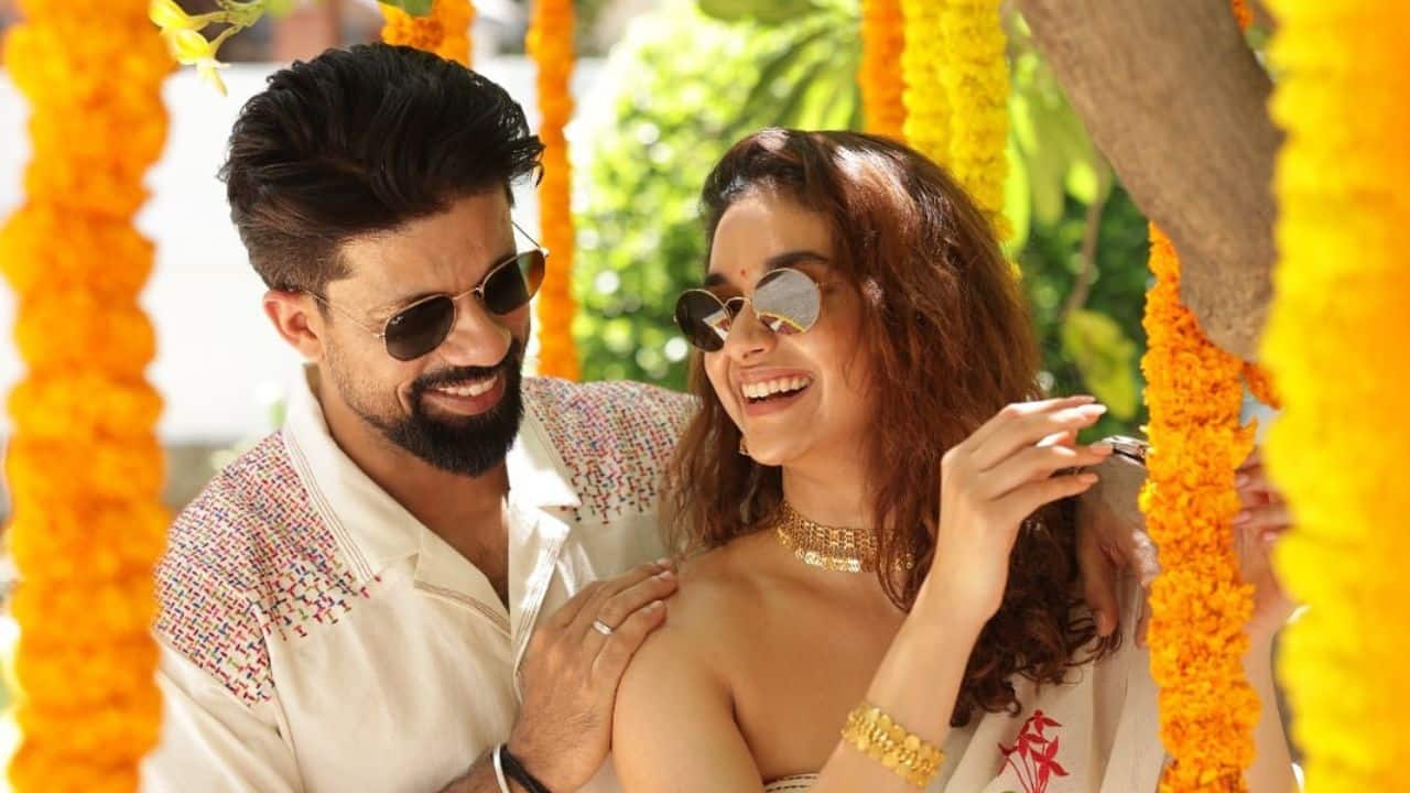 Couple Bond Under a canopy of bright yellow flowers, Keerthy and Antony laughed together. The candid capture showed their playful bond and the heart of the celebration — family, love, and happiness.