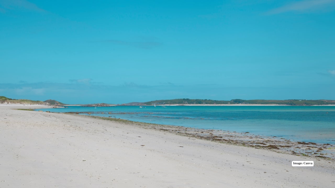 7. Pentle Bay, Scilly Isles, UK Pentle Bay feels almost Caribbean with its white sands and impossibly clear water, yet it sits quietly on England’s Scilly Isles. Remote, pristine, and rarely crowded, it’s a hidden jewel for peaceful escapes. (Image: canva)