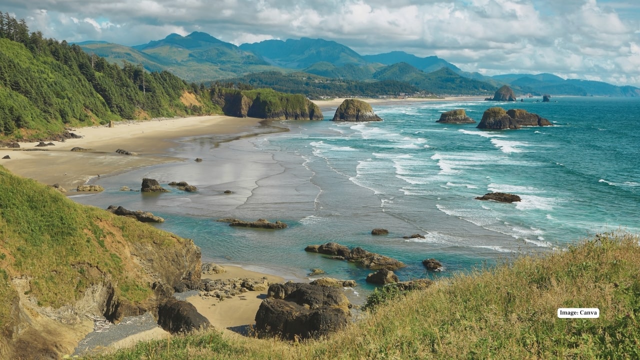 11. Cannon Beach, Oregon, USA On America’s rugged Pacific Northwest coast, Cannon Beach is iconic for Haystack Rock rising from the surf. Misty sunsets, tide pools, and dramatic skies make it a cinematic spot straight from travel postcards. (Image: canva)