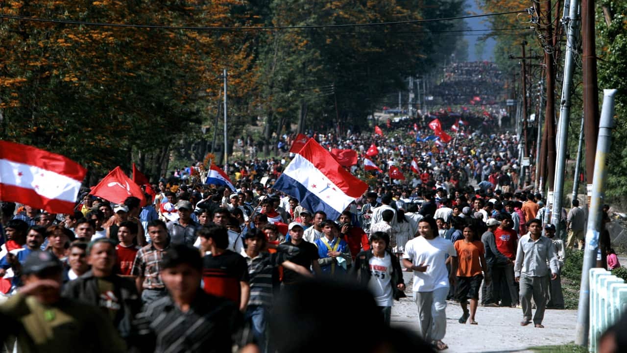 Nepalese pro-democracy protesters carry flags and banners as they stage a rally in Kathmandu in April 2006. 