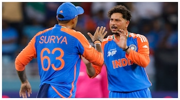 Kuldeep Yadav (R) celebrates with captain Suryakumar Yadav after taking the wicket of UAE's Rahul Chopra during the Asia Cup 2025 match between India and UAE, in Dubai. (Courtesy: PTI photo)