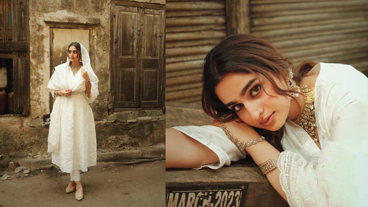 Mesmerizing and how Ayesha stuns us in an all-white anarkali suit. Her matching mojdis give us traditional styling goals. She wears a choker, which enhances her neckline. She poses in chandbalis, hath bandh, and kada, which makes her look attractive.