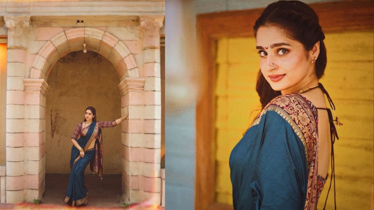 Maharashtrian look Ayesha transforms into a Marathi mulgi in a beautiful blue saree with a printed blouse, a simple neckpiece, a nath, and matching bangles. Her saree comprises a zari work border, which gives finesse to her overall look. 