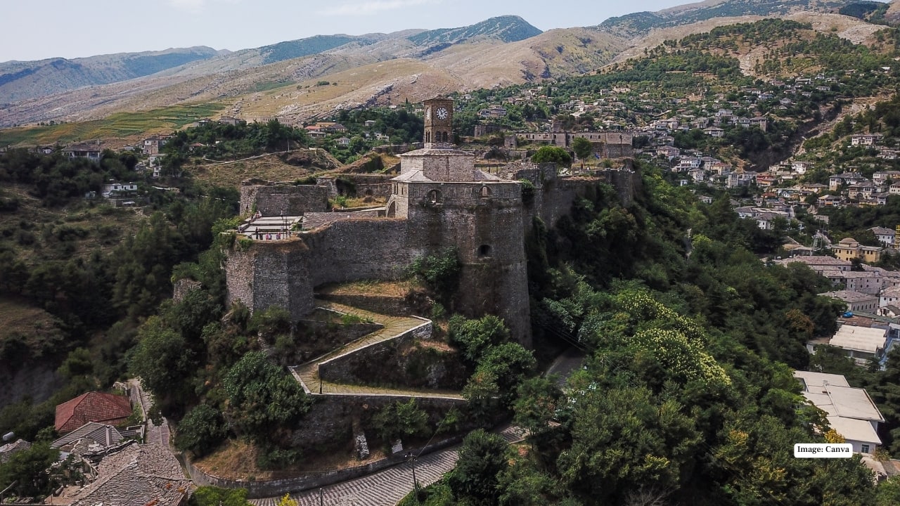 2. Gjirokastër – Step Back in Time Nicknamed the “City of Stone”, Gjirokastër is like walking through a living museum. Its cobbled streets, Ottoman-era houses, and hilltop Gjirokastër Castle transport you to another era. Explore bustling bazaars, traditional workshops, and cozy eateries that serve authentic Albanian cuisine. Why You’ll Love It: Immerse yourself in centuries of history while soaking in breathtaking hillside views. (Image: Canva)