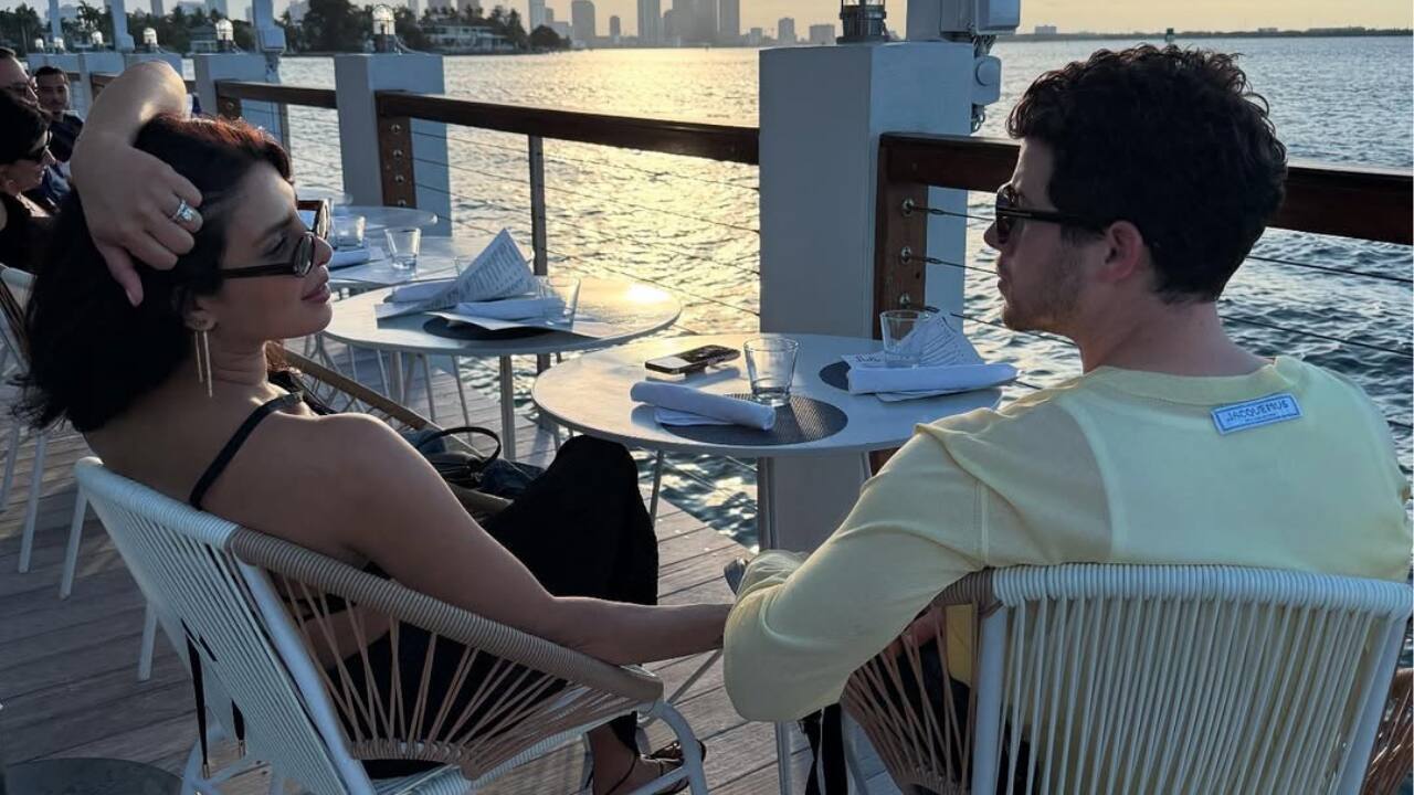 Romance in the Golden Hour  Priyanka Chopra and Nick Jonas are lost in each other's gazes as they enjoy a calm sunset moment by the water. The couple exudes peace and connection as they hold hands and enjoy the golden hour light. Their easy chemistry and the understated beauty of love are captured in this small dinner date.